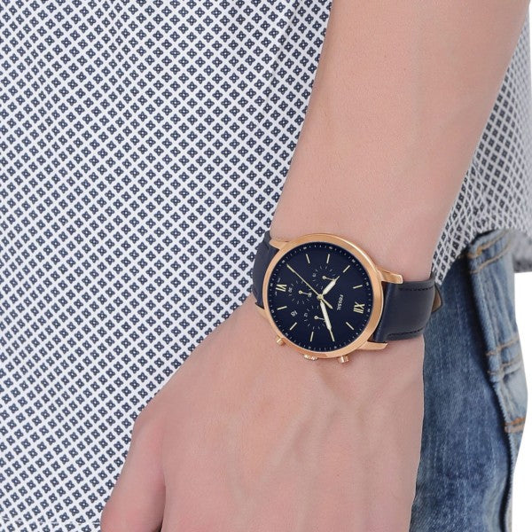 Fossil Neutra Chronograph worn on wrist showing navy dial and leather strap