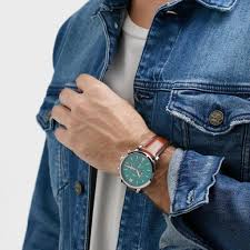 Fossil Neutra chronograph watch worn on wrist with green dial visible on denim shirt sleeve
