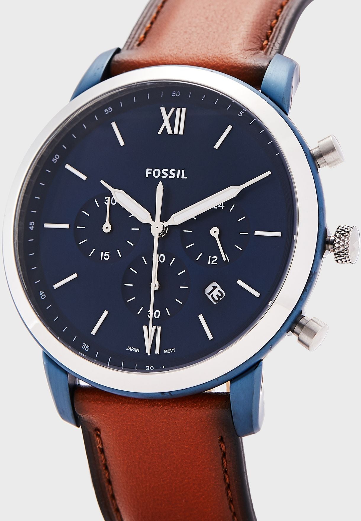 Fossil Neutra chronograph watch angle view showing blue case, blue dial and cognac leather strap