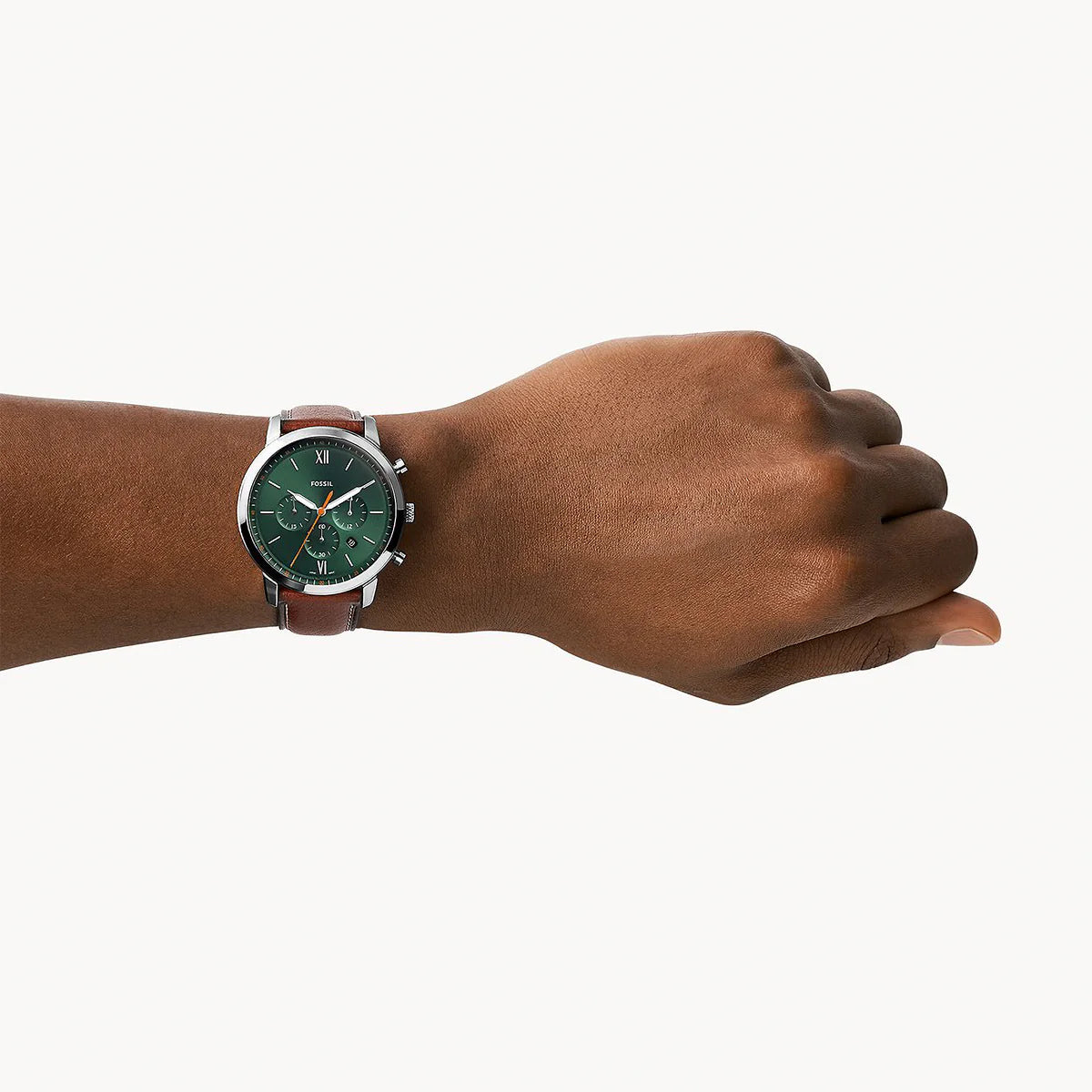 Fossil Neutra FS5902 chronograph watch worn on wrist with green dial and brown leather strap