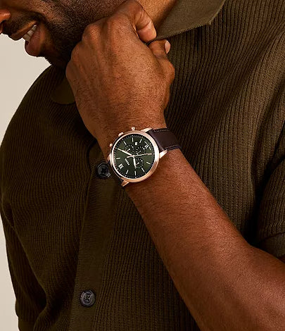 Fossil Neutra FS6073 chronograph watch worn on wrist with green dial and brown leather strap