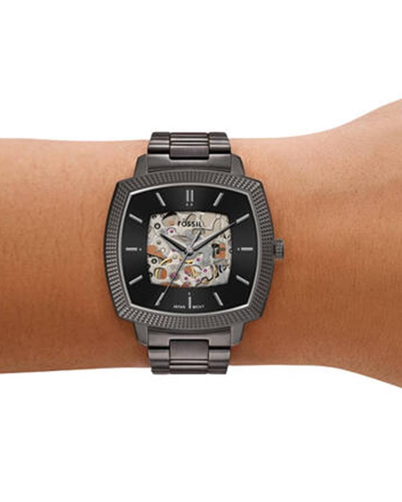 Fossil Machine Luxe watch worn on wrist showing gunmetal finish and skeleton dial