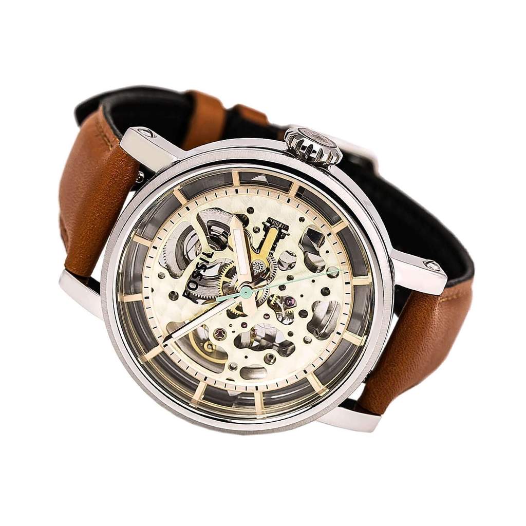 Fossil Original Boyfriend skeleton watch worn on wrist with cognac and black leather strap