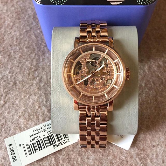 Fossil Original Boyfriend rose gold automatic skeleton watch on white display pillow