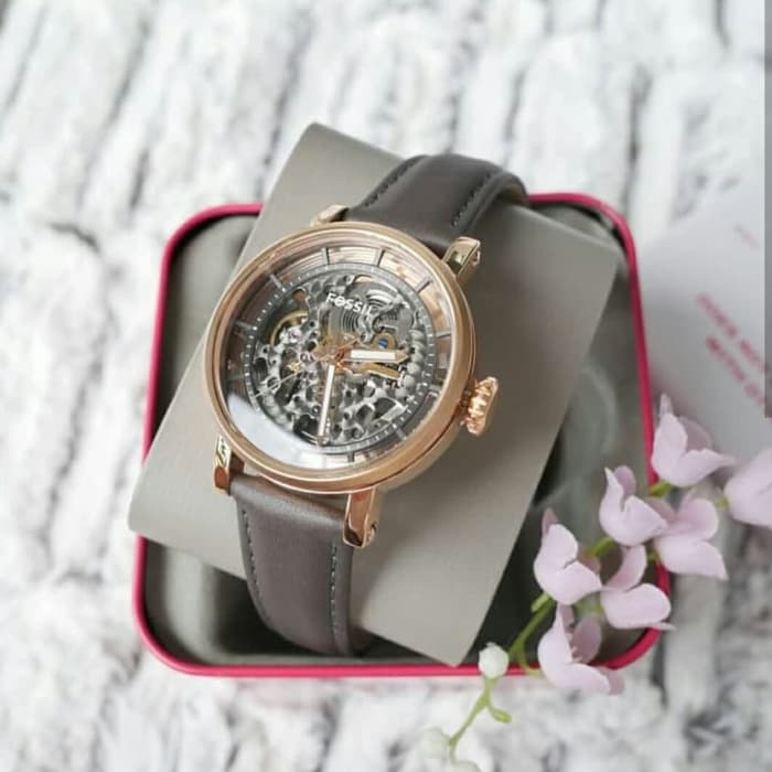 Watch with black leather strap displayed in Fossil branded gift box with accessories
