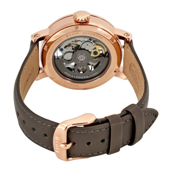 Watch caseback showing automatic movement visible through transparent crystal