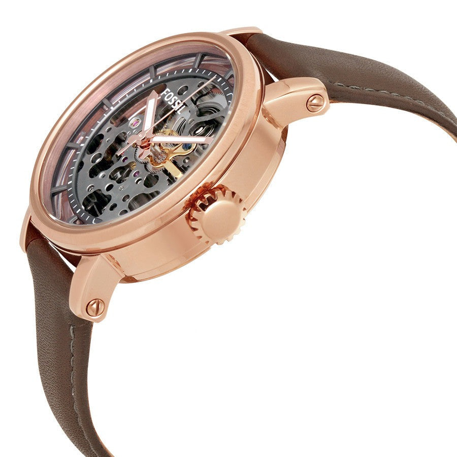 Angled view of skeleton dial and rose gold case with crown and leather strap