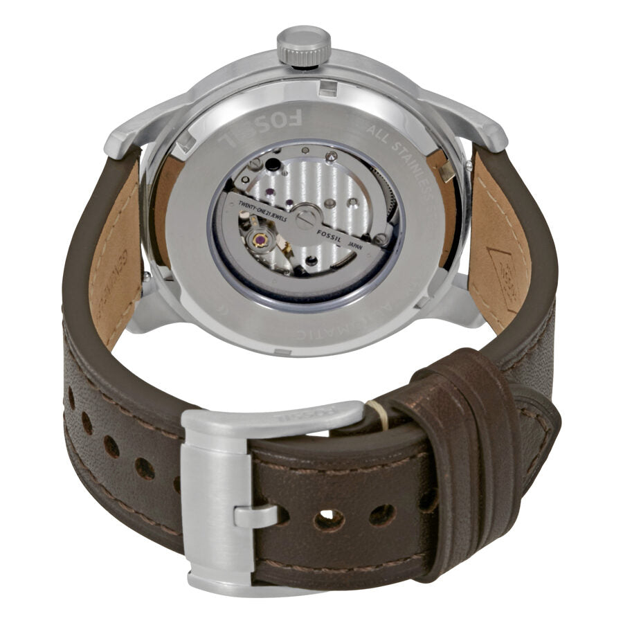 Fossil Pilot 54 watch case back showing automatic movement and brown leather strap