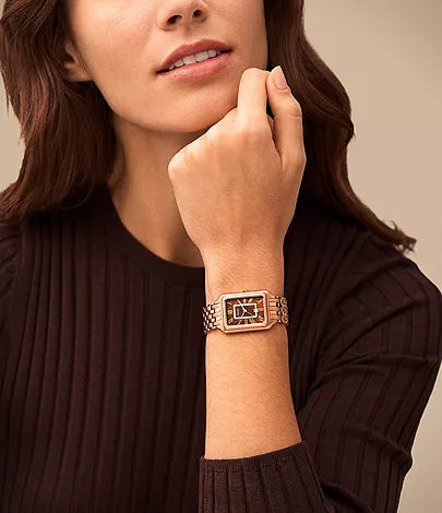 Fossil Raquel rose gold watch worn on wrist with rectangular case and bracelet strap