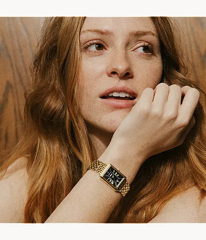 Fossil Raquel gold-tone women's watch worn on wrist with black dial