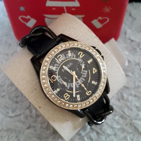 Fossil Riley watch worn on wrist with black leather strap and crystal-set bezel
