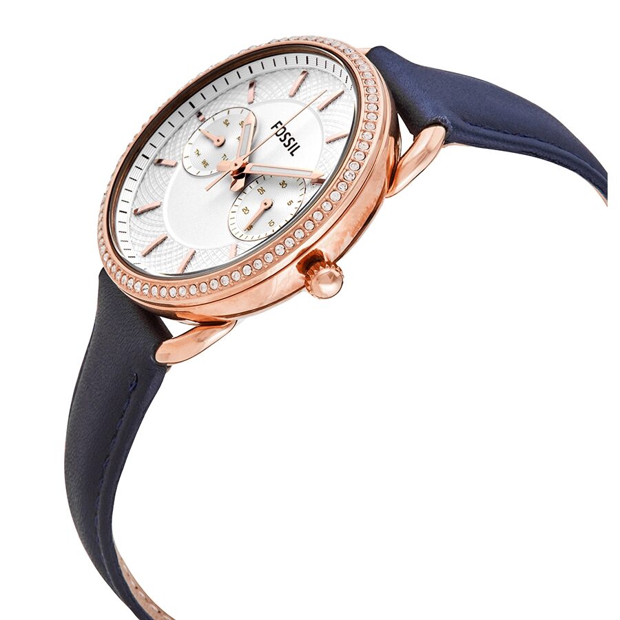 Fossil Tailor watch at angle showing rose gold case with crystal bezel and navy leather strap