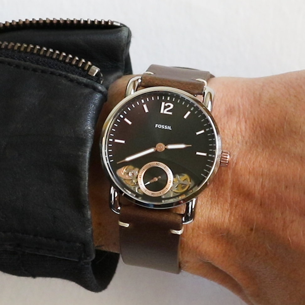 Fossil The Commuter watch worn on wrist with brown leather strap