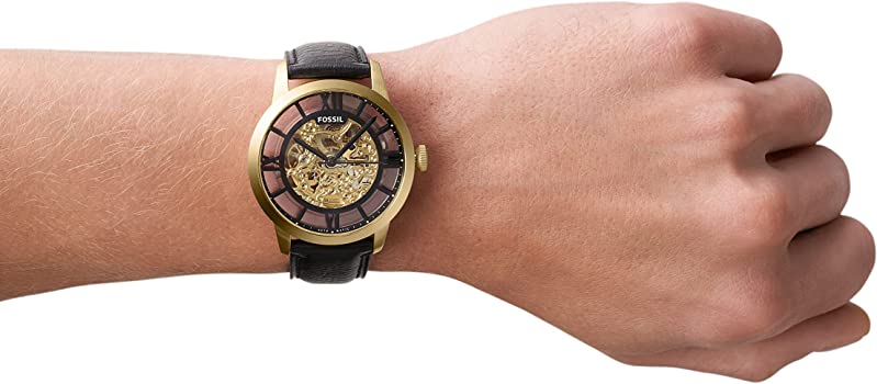 Fossil Townsman automatic watch on wrist with skeleton dial and black leather band