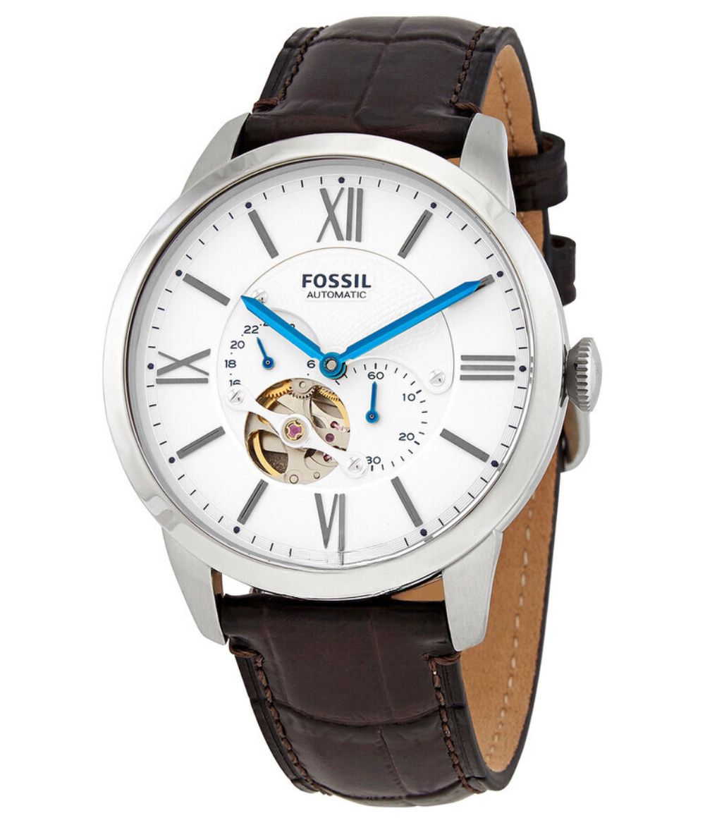 Fossil Townsman automatic chronograph watch with white dial, silver case, blue hands, Roman numerals, and visible balance wheel