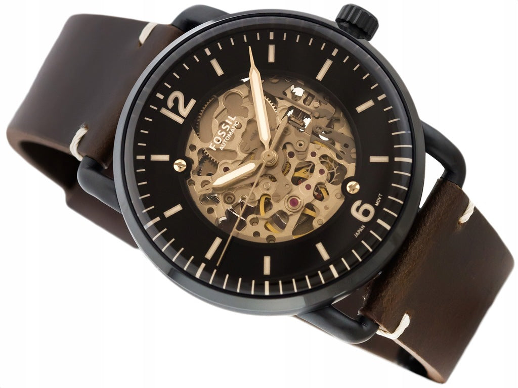 Close-up of Fossil Townsman skeleton dial with exposed automatic movement and gold hands