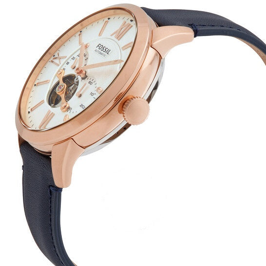 Side angle view of Fossil Townsman watch showing rose gold case, white dial, and navy leather strap