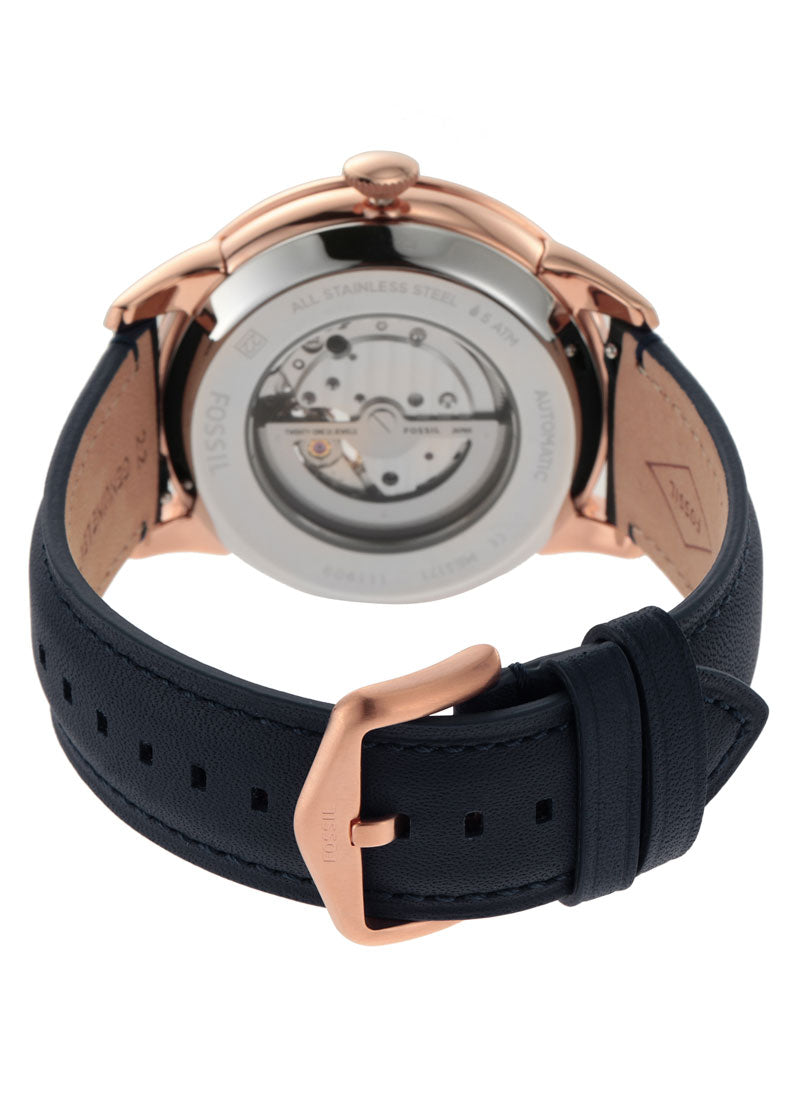 Case back view of Fossil Townsman showing visible automatic tourbillon movement and navy leather strap
