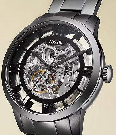 Fossil Townsman dial detail showing visible mechanical movement with goldtone accents and Roman numerals