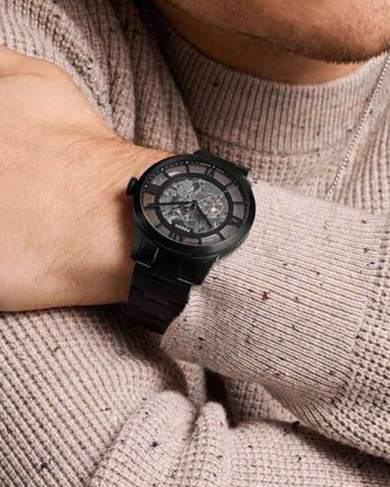 Fossil Townsman black watch worn on wrist with skeleton dial visible