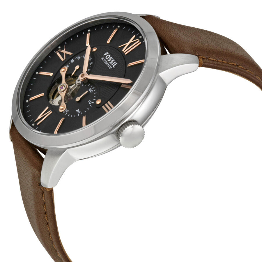 Fossil Townsman watch at angle showing silver case, brown leather strap, and open skeleton dial