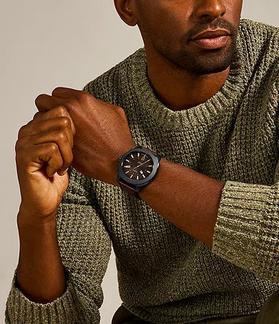 Fossil Machine watch worn on wrist with dark brown dial and leather strap
