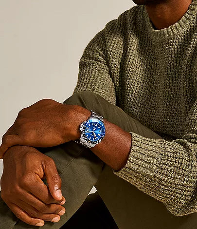 Fossil Blue GMT men's watch worn on wrist with blue dial visible