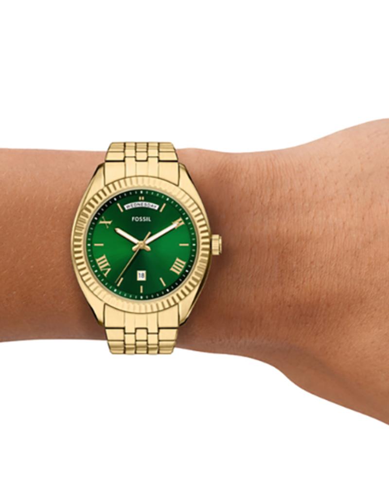 Campbell watch worn on wrist showing green dial and gold-tone stainless steel bracelet