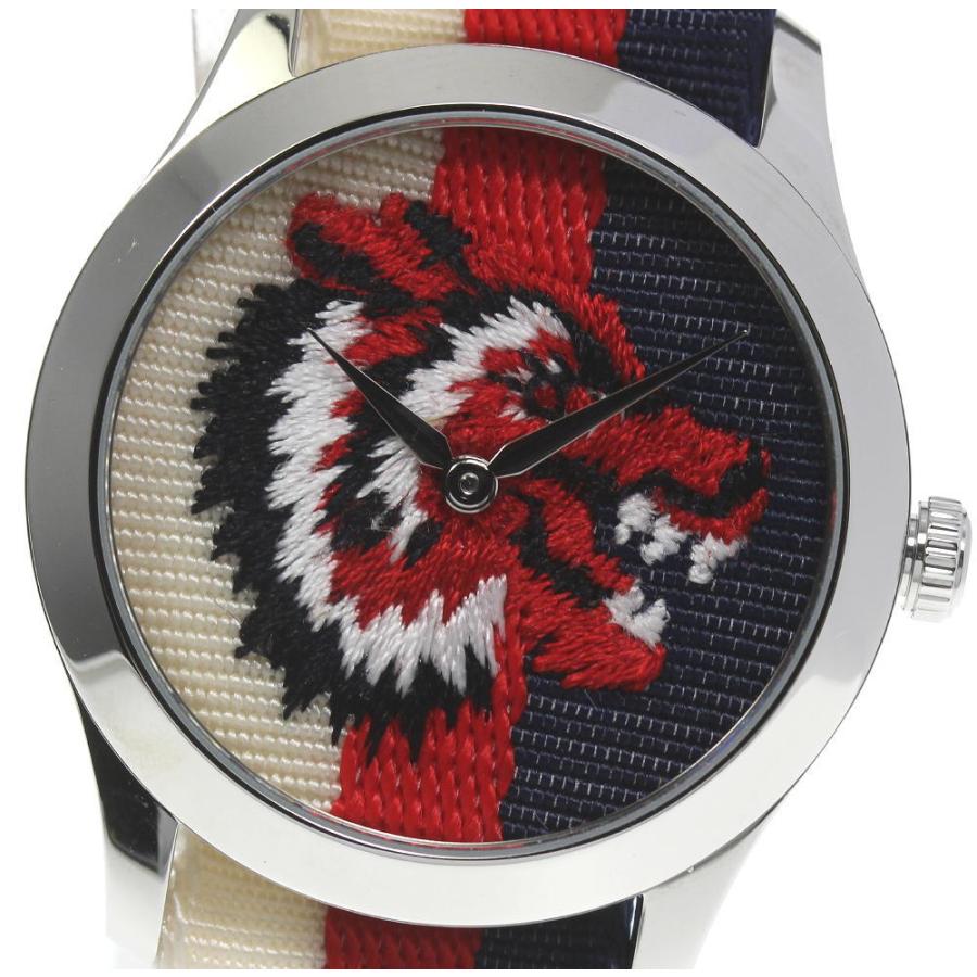 Close-up of G-Timeless lion emblem dial with red, white and navy colors