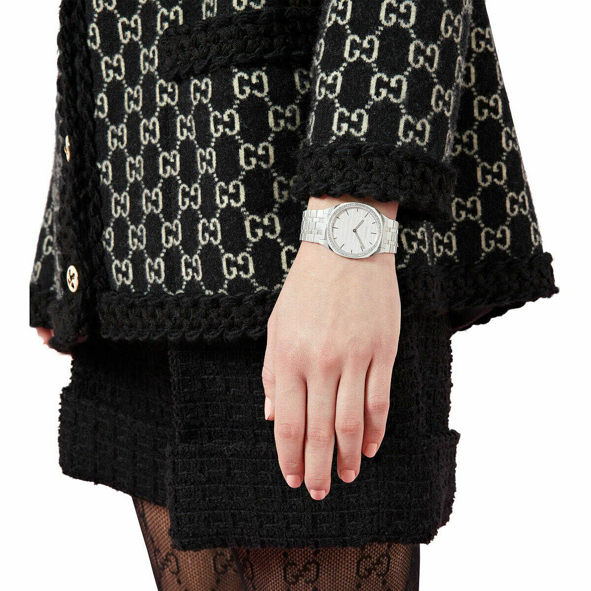 Gucci 25H watch worn on wrist with silver dial and diamond bezel visible