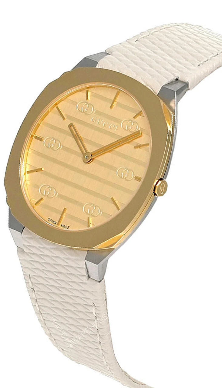Gucci 25H watch at angle showing golden brass dial and white leather strap