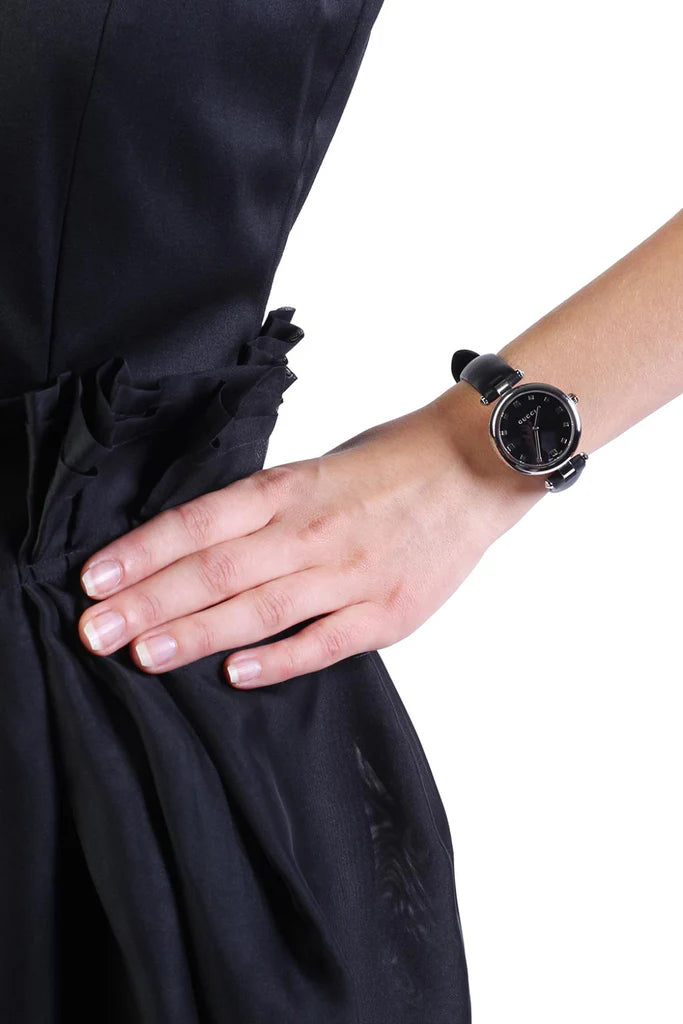 Gucci Diamantissima watch worn on wrist, displaying black dial and black leather strap