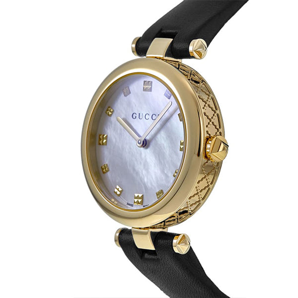 Side view of Gucci Diamantissima watch showing quilted gold-tone case and black leather strap