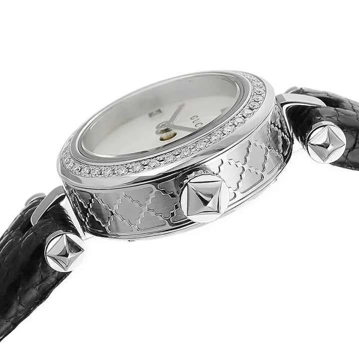 Angled view of Gucci Diamantissima watch with diamond bezel and black quilted leather strap