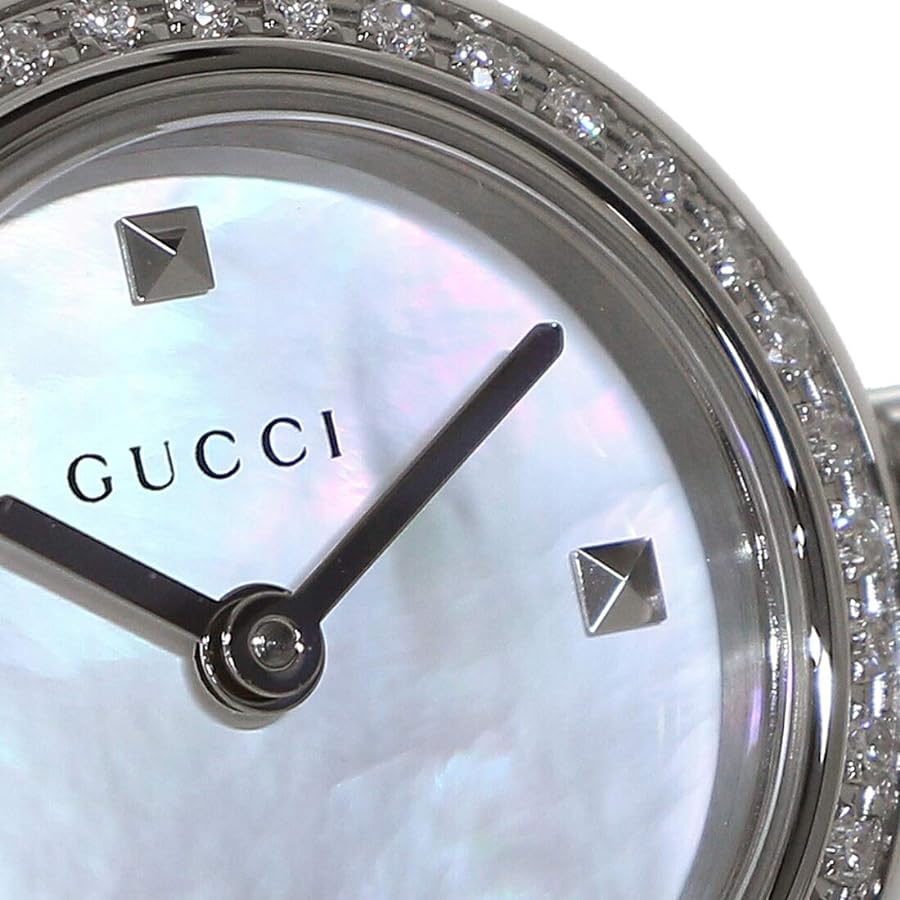 Close-up of Gucci Diamantissima dial showing mother of pearl, Gucci text, and pyramid markers