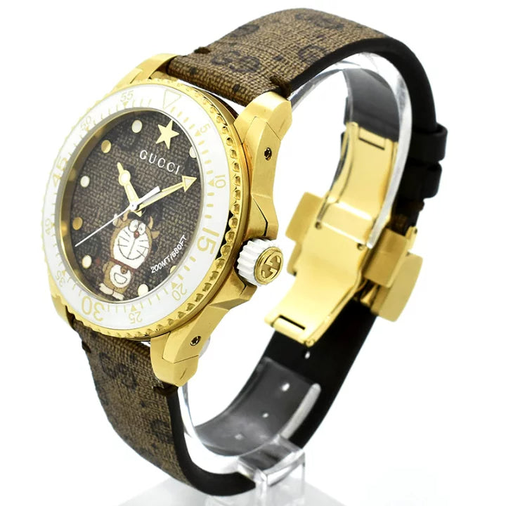 Gucci Dive Doraemon YA136334 three-quarter view showing gold PVD case and brown canvas strap