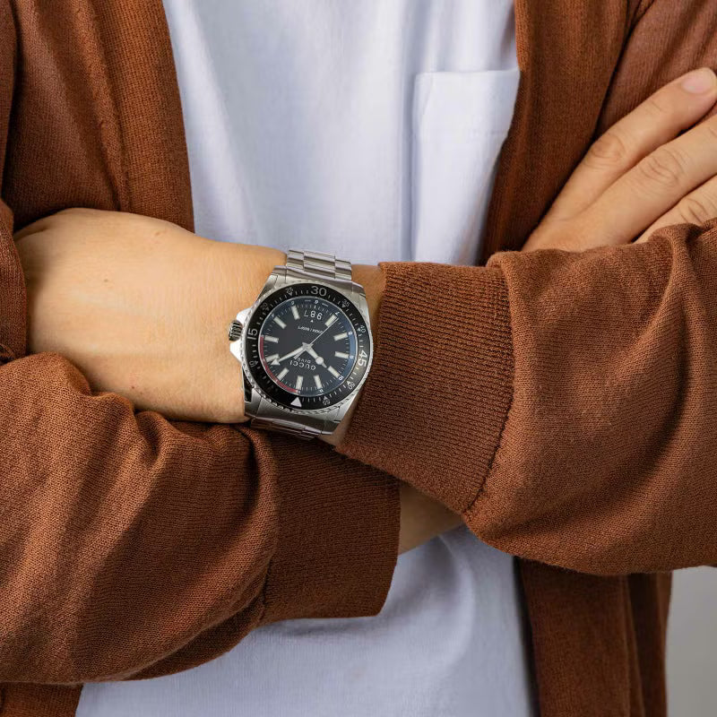 Gucci Dive YA136212 men's watch worn on wrist with silver steel bracelet and black dial