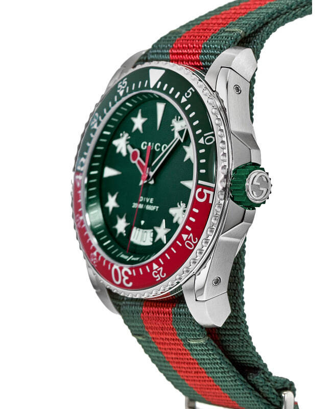 Side profile showing stainless steel case, crown, and red/green striped fabric strap