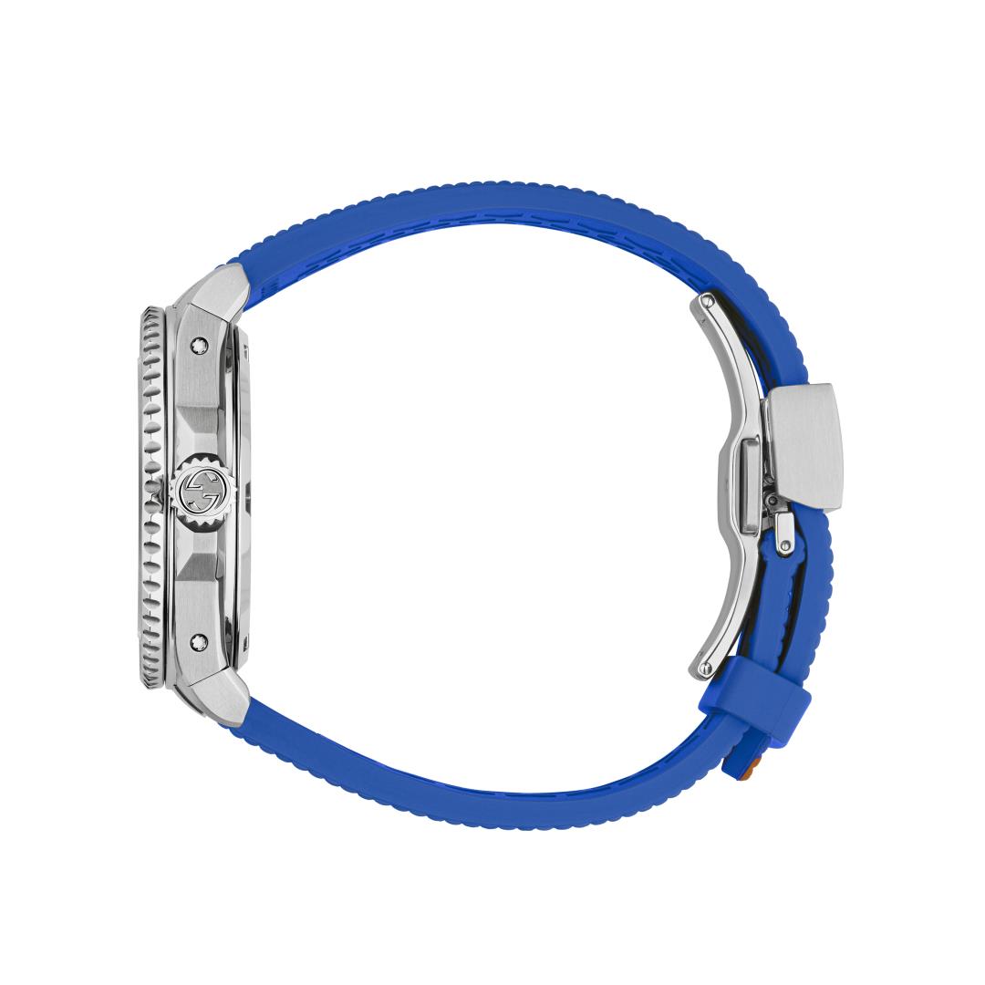 Gucci Dive watch on wrist showing full strap with blue and red rubber bands