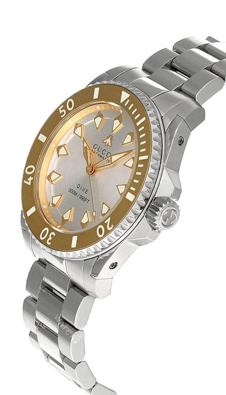 Gucci Dive watch angled view showing silver dial, gold bezel, and steel bracelet