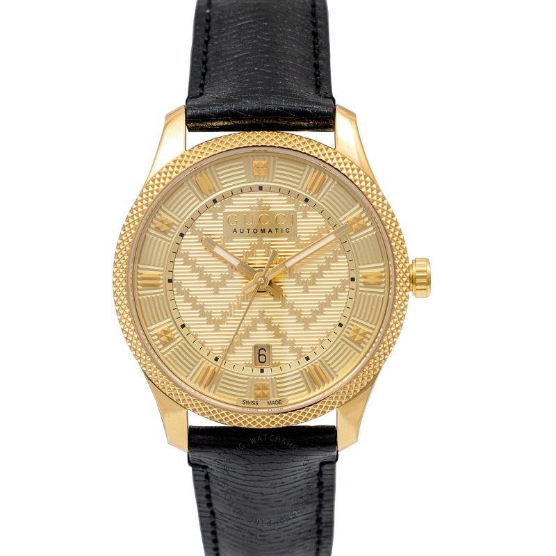 Gucci Eryx watch with gold chevron dial, gold case, and black leather strap
