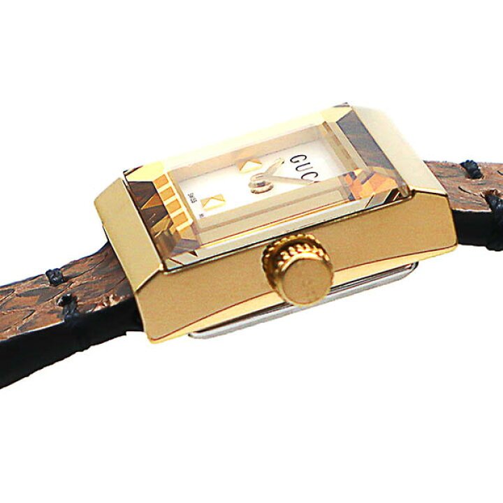 Gucci G-Frame watch worn on wrist showing gold case, cream dial, and leather strap