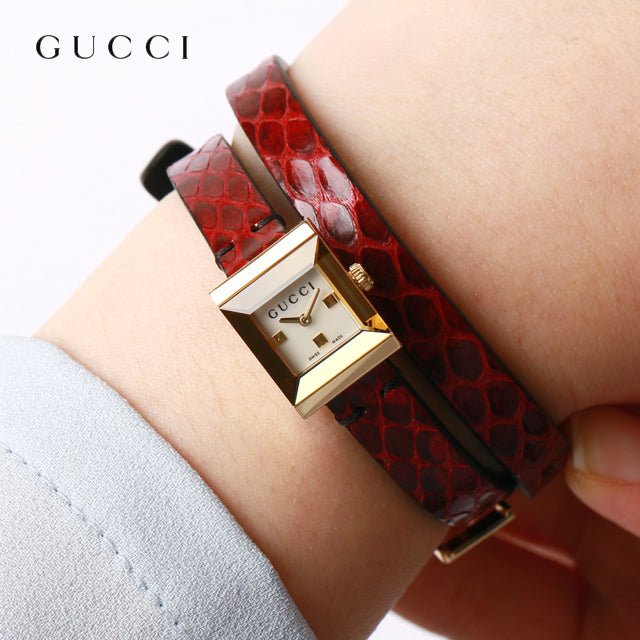 Gucci G-Frame women's watch on wrist with double-wrapped red leather band