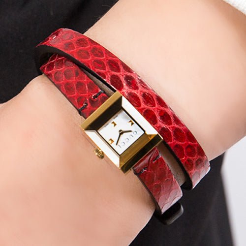 Gucci G-Frame watch worn on wrist with red quilted leather strap