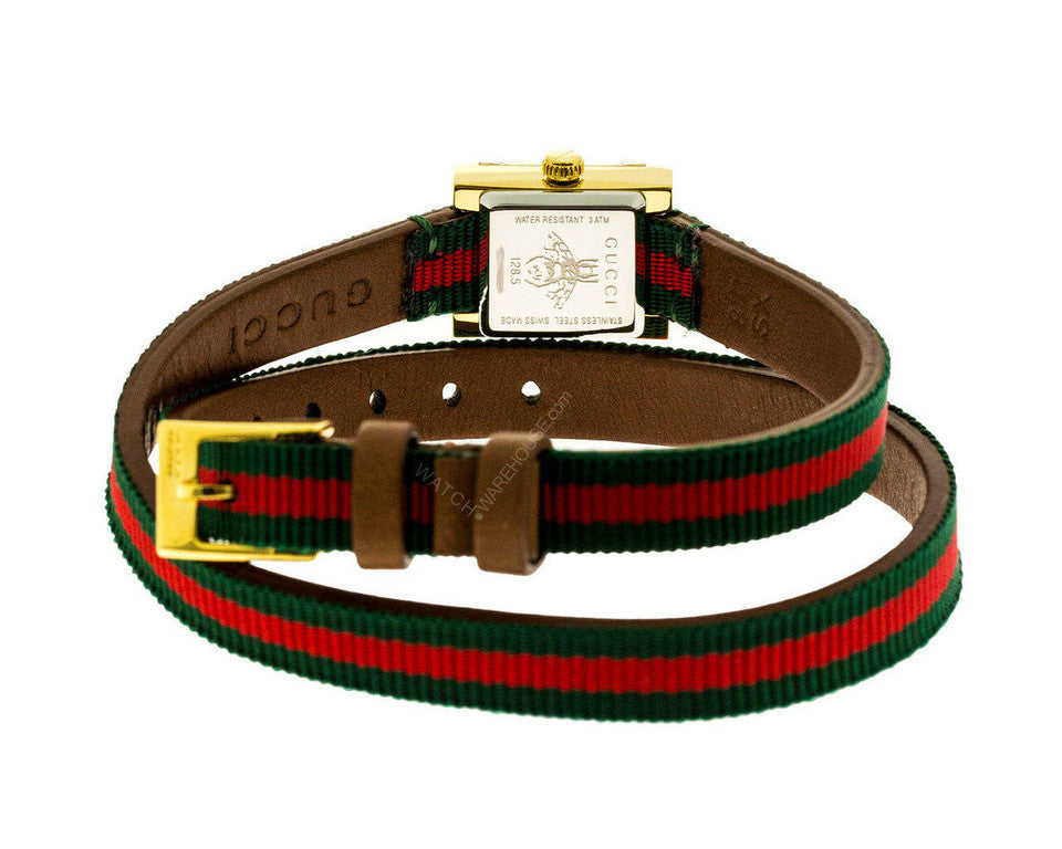 Gucci G-Frame watch on wrist showing red-green striped canvas strap and rectangular gold case