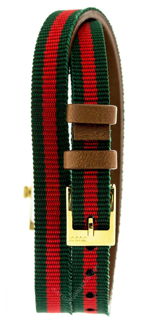 Gucci G-Frame watch strap detail showing red-green striped canvas with brown leather backing and gold buckle