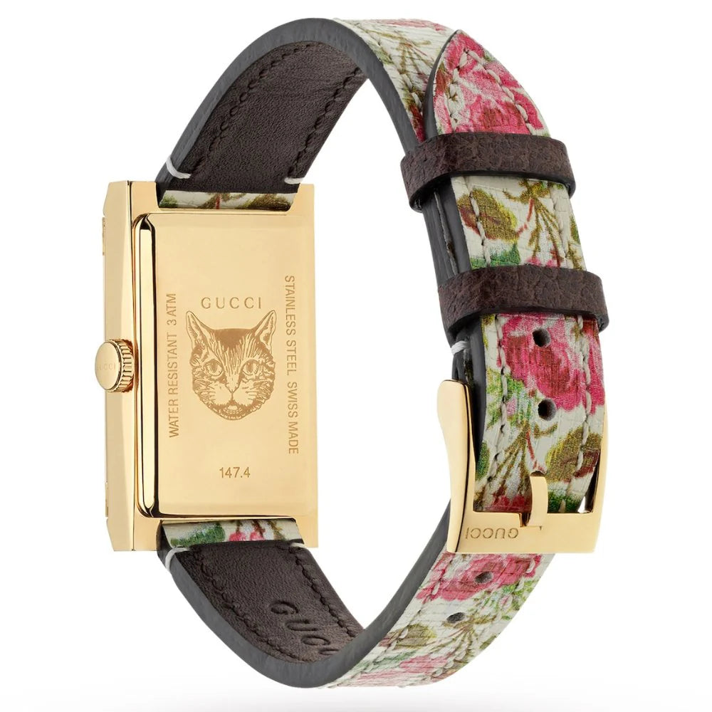 Gucci G-Frame watch side view displaying rectangular gold case with cat logo, floral strap, and brown leather accents