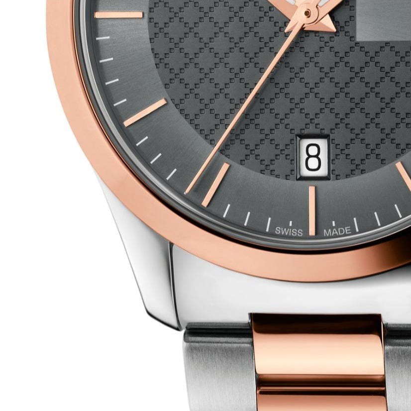 Gucci G-Timeless 27mm dial close-up with rose gold hands and indices detail