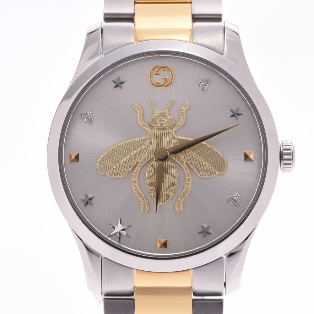 Close-up of G-Timeless dial with gold bee, Gucci logo, and star indexes