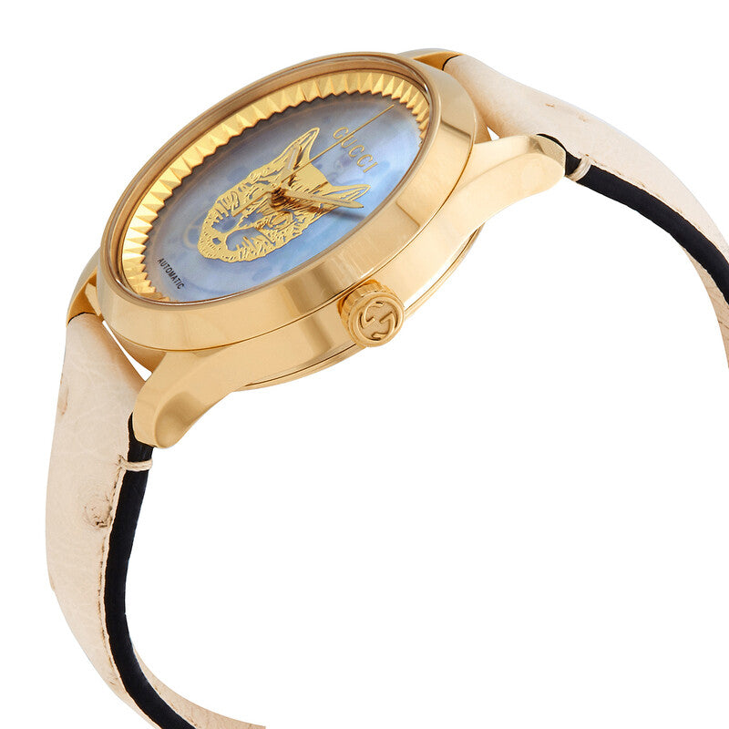 Angled side view of Gucci G Timeless automatic watch with iridescent dial and pink leather strap with black stripe